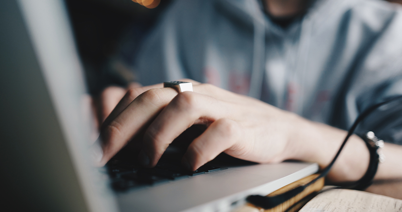 a guy working on a laptop. Close up shot. 